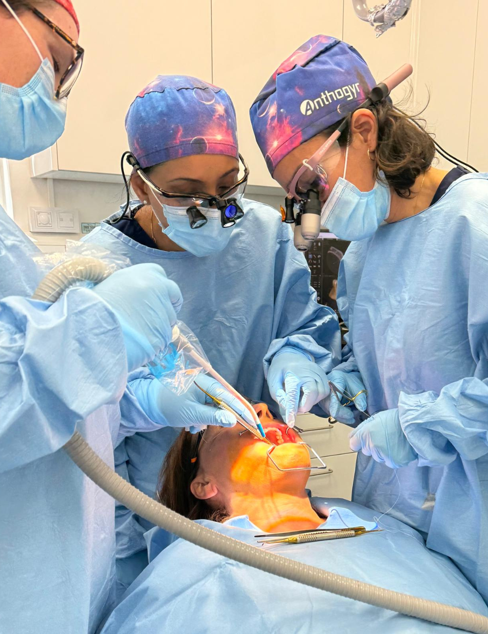 Dr Monika photo during surgery - mentoring